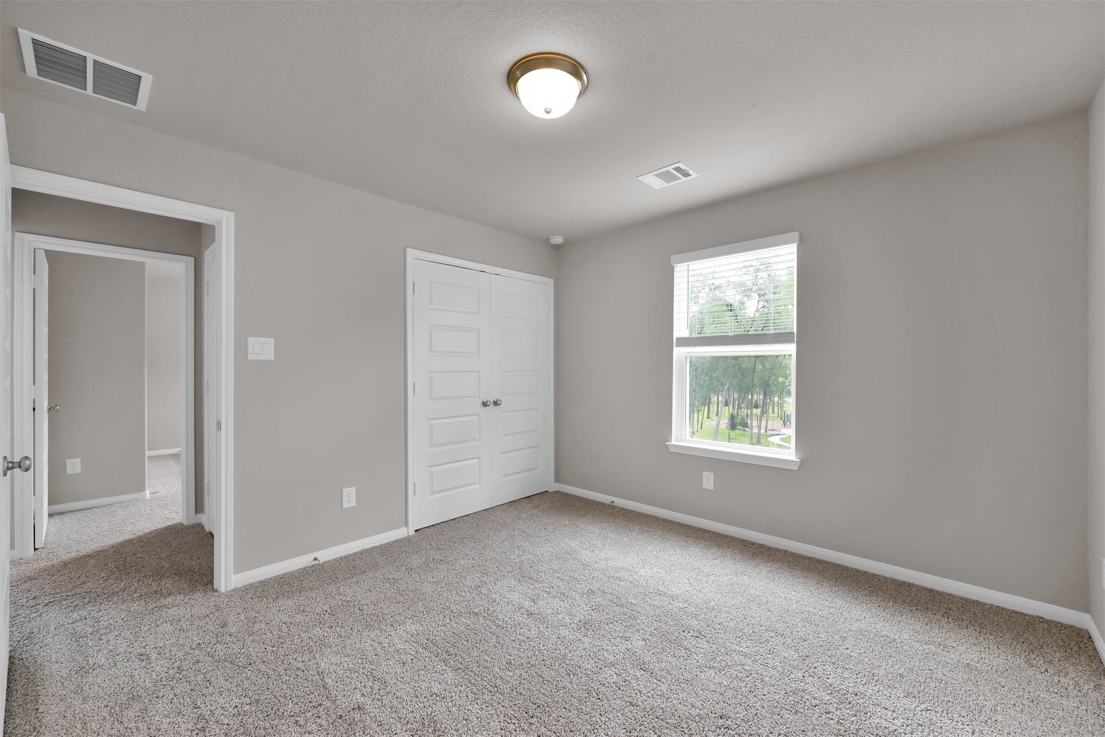 213 Harper Ridge Drive Montgomery, TX 77316 - Photo 23 of 34 an empty room with a fan & windows