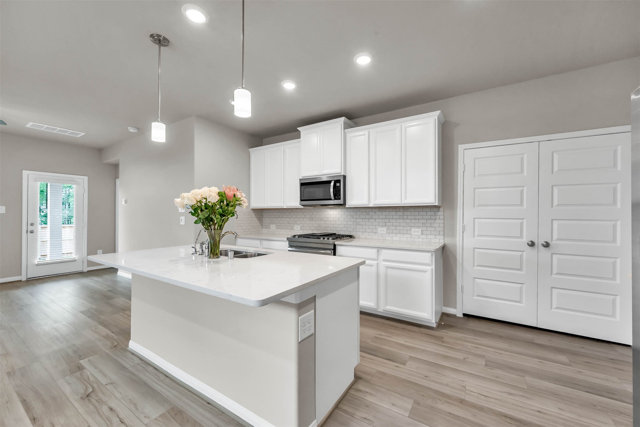 213 Harper Ridge Drive Montgomery, TX 77316 - Photo 10 of 34 a kitchen with white cabinets and stainless steel appliances