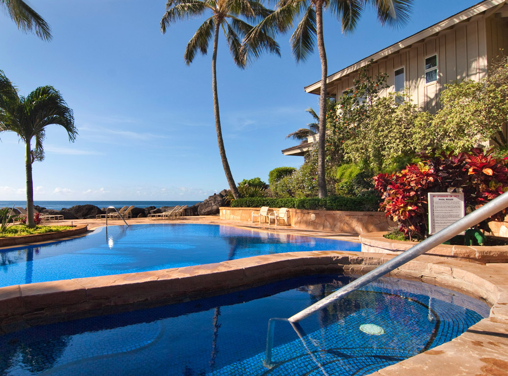 2640 Puuholo Road, Unit 212 Koloa, HI 96756 - Photo 2 of 10 a view of a swimming pool with a table and chairs