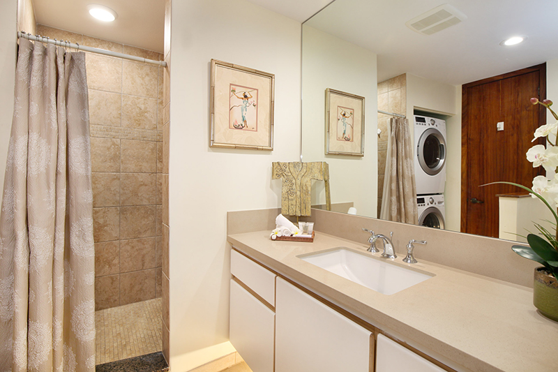 2640 Puuholo Road, Unit 212 Koloa, HI 96756 - Photo 10 of 10 a bathroom with a granite countertop sink a mirror and a shower