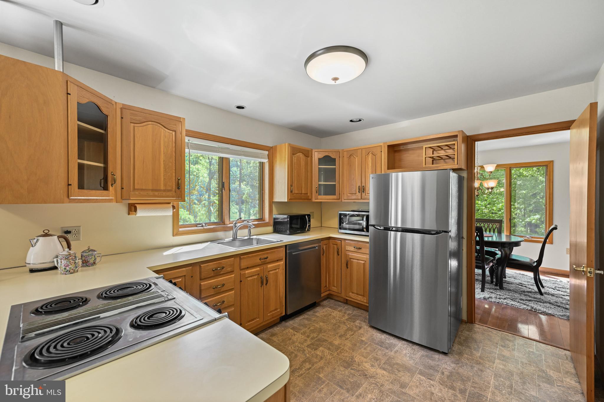 1680 East Street Road Kennett Square, PA 19348 - Photo 11 of 30 a kitchen with a refrigerator a stove a sink and a dining table