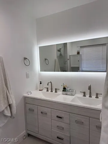 a bathroom with a double vanity sink and mirror