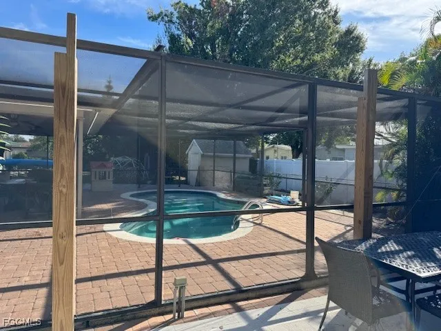 a backyard of a house with barbeque oven table and chairs