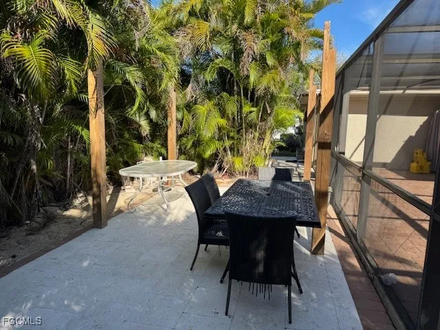 a backyard of a house with table and chairs