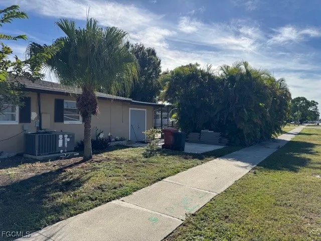 a backyard of a house with yard and outdoor seating