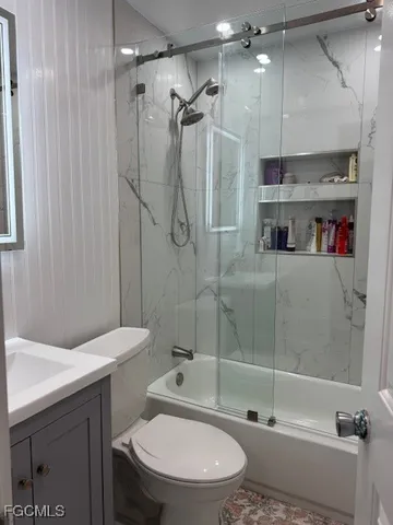 a bathroom with a shower a toilet and a shower