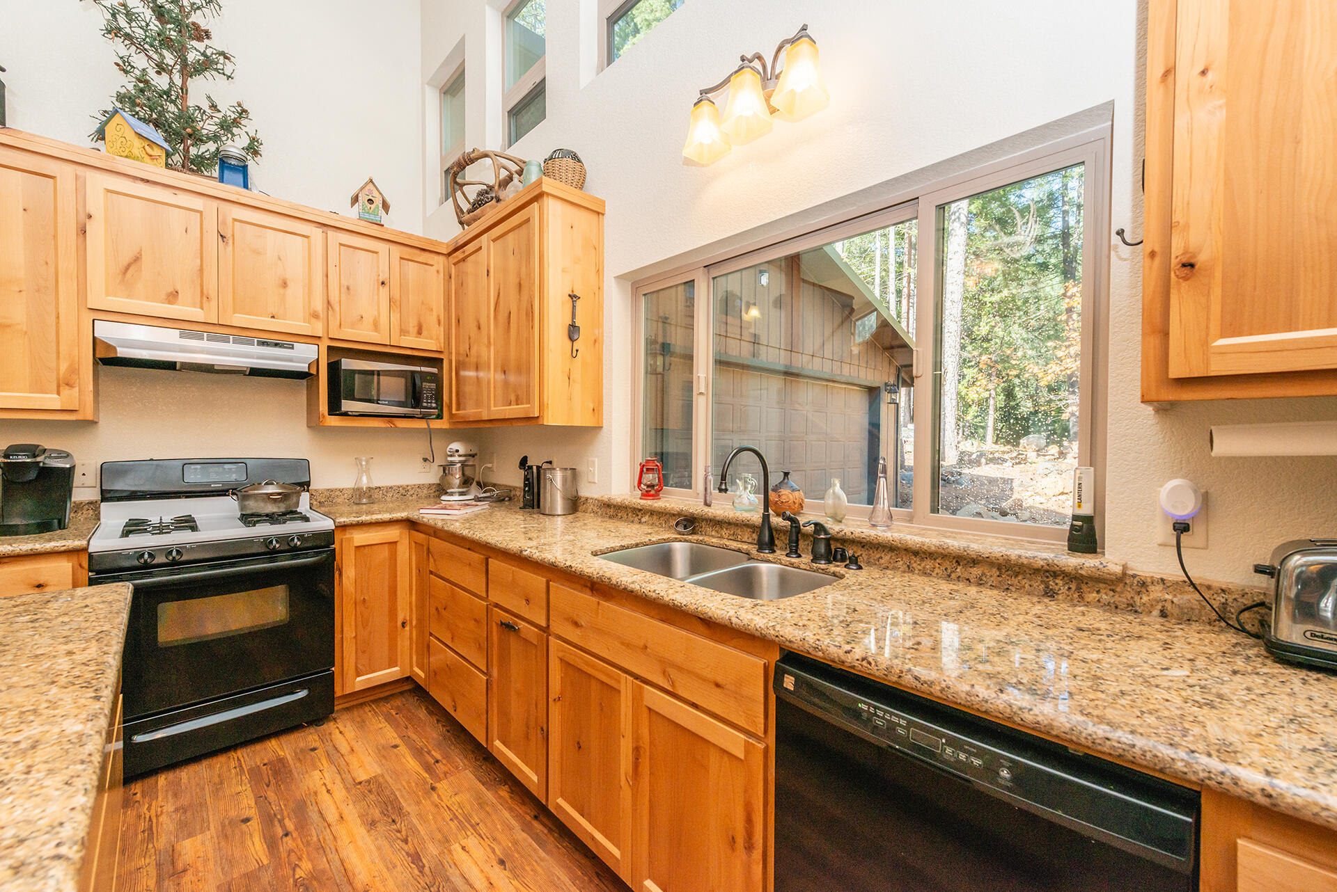 851 Mountain Aire Road Trinity Center, CA 96091 - Photo 25 of 54 a kitchen with stainless steel appliances granite countertop a sink stove and cabinets