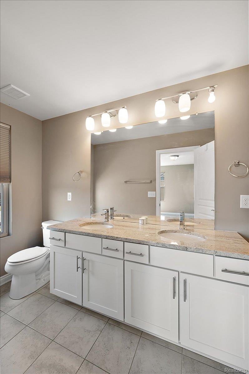 2877 Hartwick Drive Rochester, MI 48307 - Photo 30 of 44 Bathroom featuring double vanity and toilet
