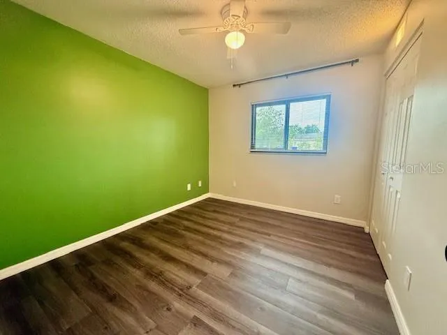 a view of room with window and ceiling fan