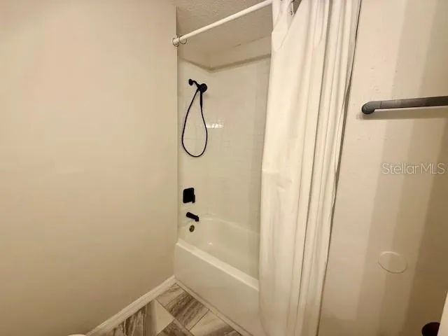 a bathroom with a bathtub and a shower