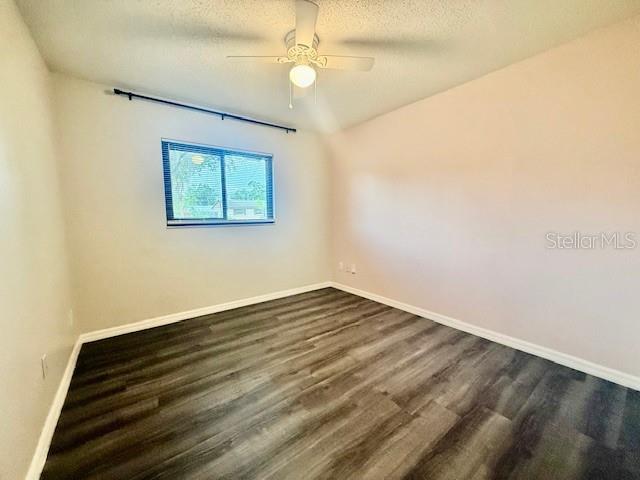 1819 Oak Street DeLand, FL 32724 - Photo 20 of 26 an empty room with wooden floor chandelier fan and windows