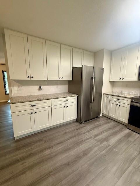 1819 Oak Street DeLand, FL 32724 - Photo 7 of 26 a kitchen with white cabinets and white stainless steel appliances
