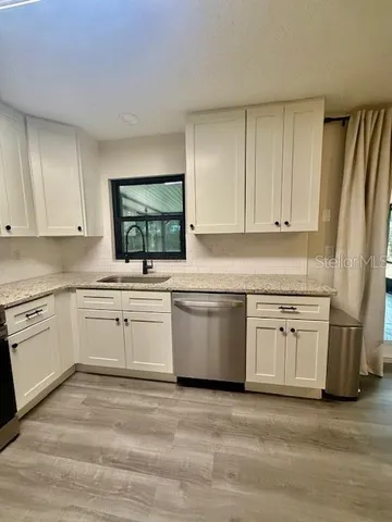 a kitchen with appliances cabinets and a sink