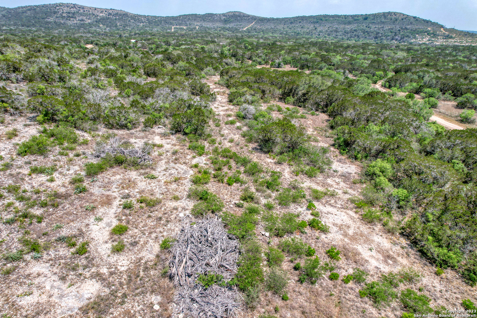0 Brushy Creek Ranch Road Concan, TX 78838 - Photo 22 of 27 a view of a lush green hillside and houses