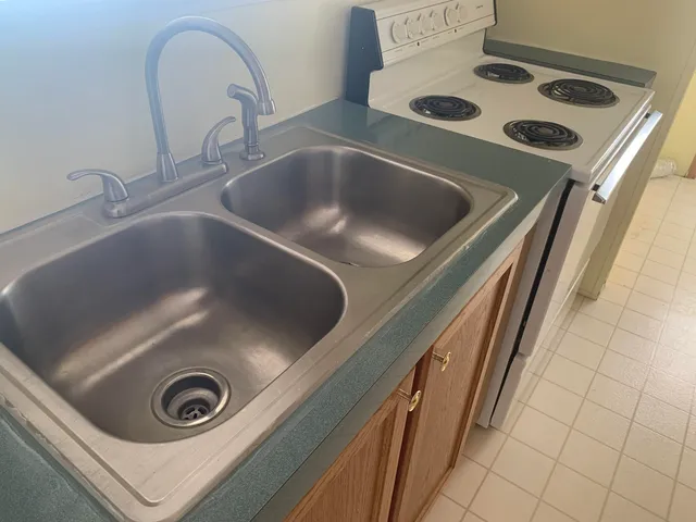 a kitchen that has a sink and a stove