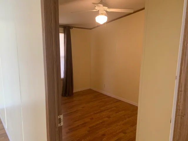 a view of a room with wooden floor