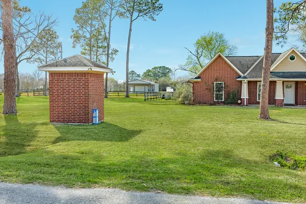 a front view of house with yard and green space
