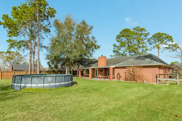 a view of a house with a yard and sitting area