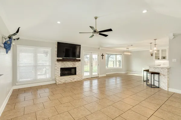 a view of an empty room with a fireplace and a window