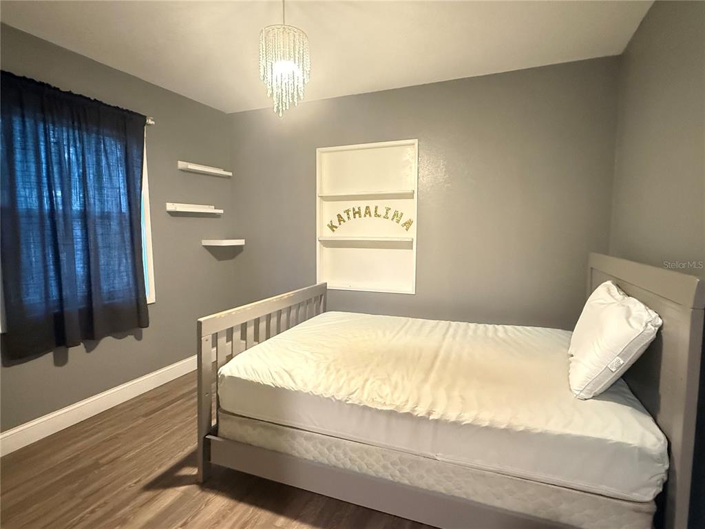 644 Indiana Street Orlando, FL 32805 - Photo 11 of 15 a bedroom with a bed and a window