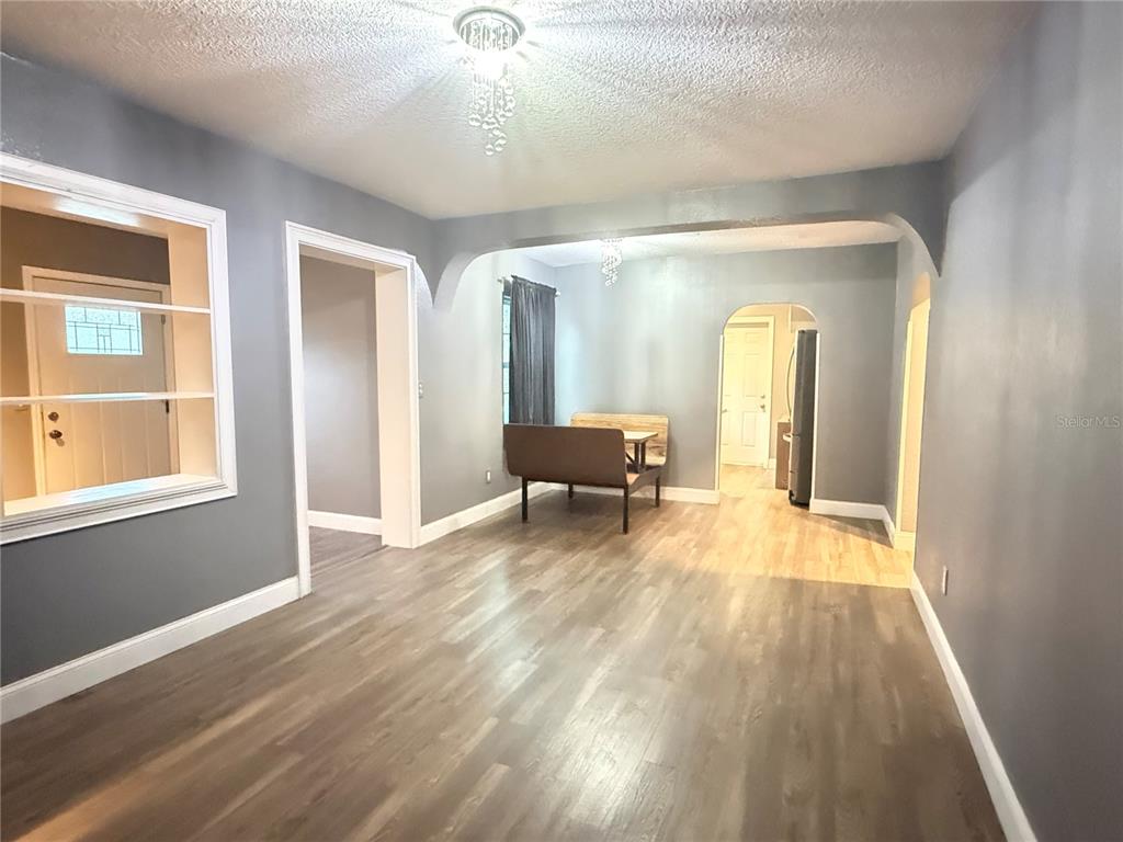 644 Indiana Street Orlando, FL 32805 - Photo 2 of 15 a view of a livingroom with wooden floor and furniture