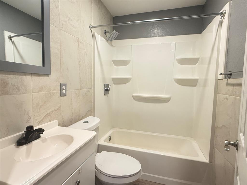 644 Indiana Street Orlando, FL 32805 - Photo 3 of 15 a bathroom with a sink toilet and shower
