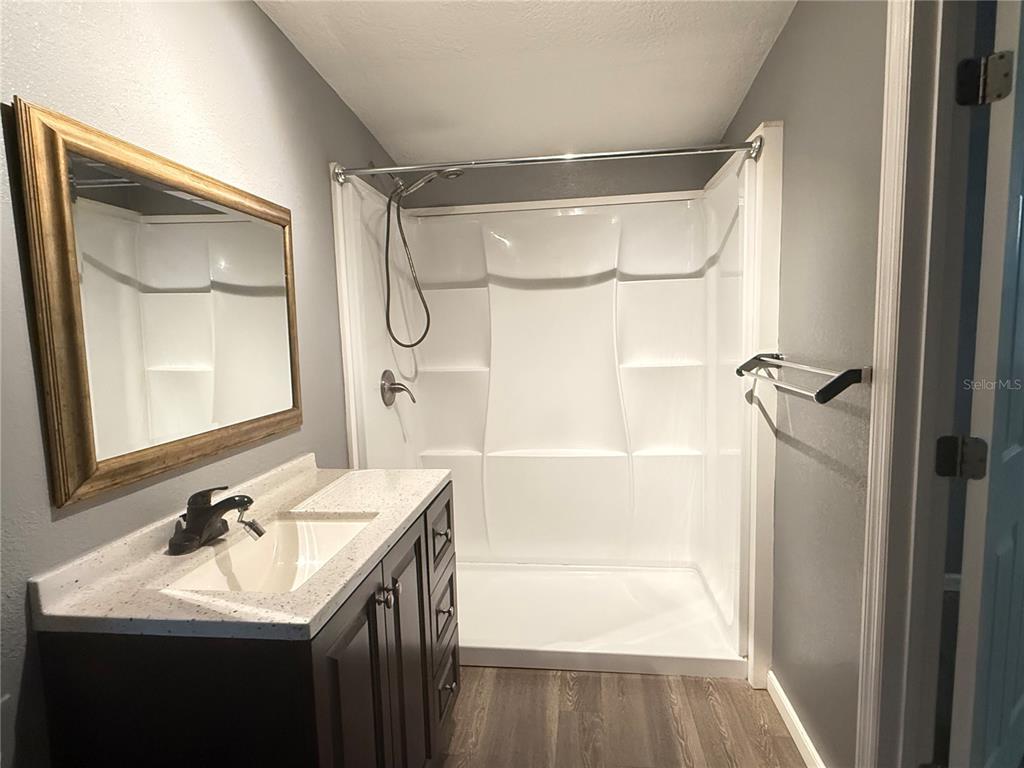 644 Indiana Street Orlando, FL 32805 - Photo 6 of 15 a bathroom with a sink vanity granite tub shower and a mirror
