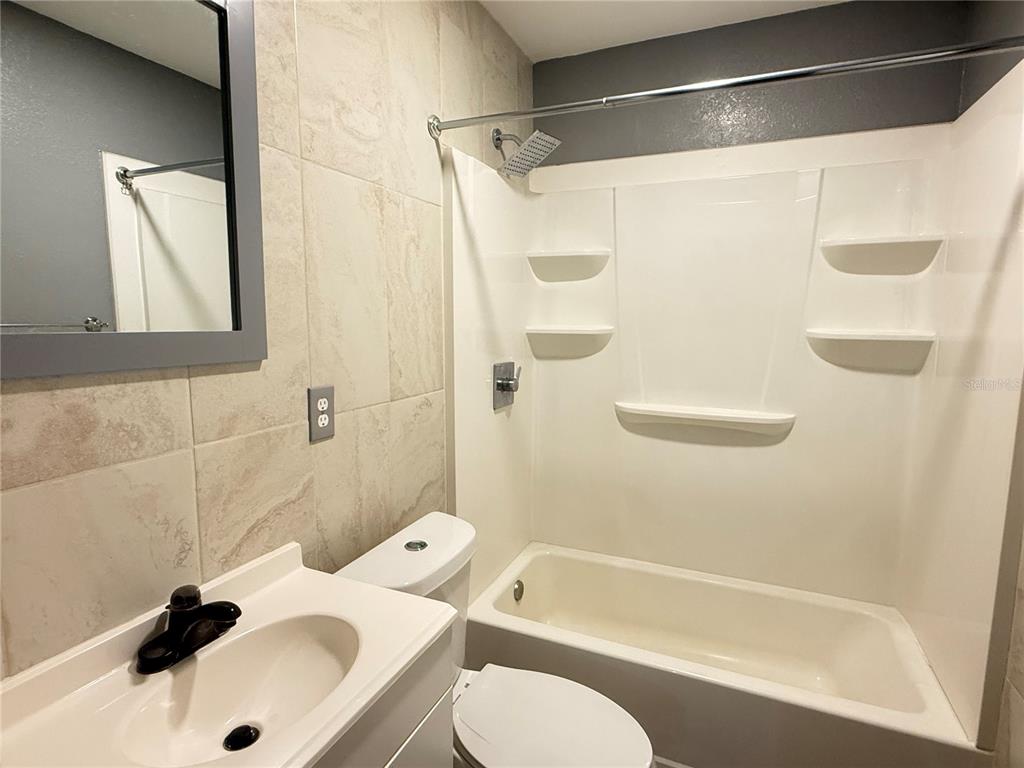 644 Indiana Street Orlando, FL 32805 - Photo 7 of 15 a bathroom with a sink toilet and shower