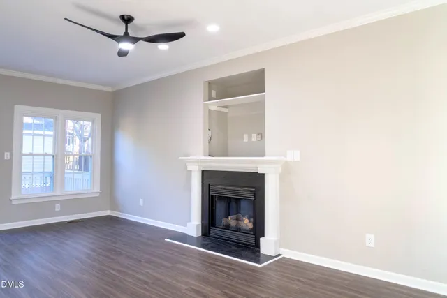 a view of a livingroom with a fireplace and window