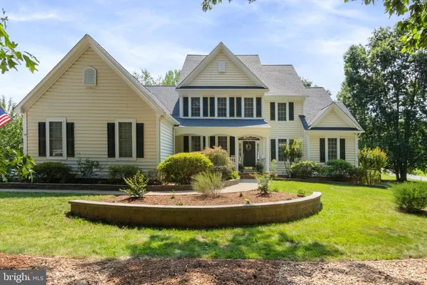 a front view of a house with a yard table and chairs