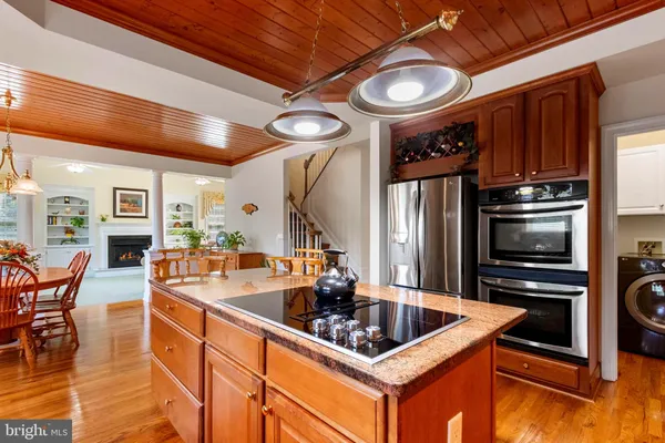 a kitchen with stainless steel appliances granite countertop a sink a stove and a refrigerator