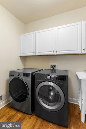a utility room with sink dryer and washer