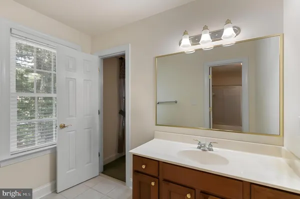 a bathroom with a sink a vanity and a mirror