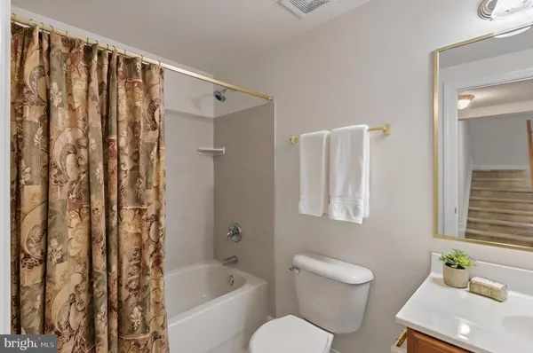 a bathroom with a toilet a sink and bathtub