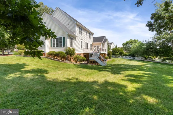 a view of a house with a big yard and sitting area