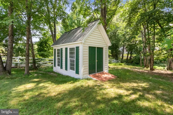 a front view of a house with potted plants
