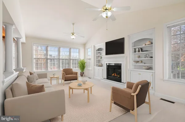 a living room with furniture a fireplace and a flat screen tv
