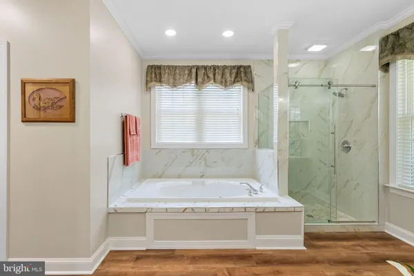 a bathroom with a tub a sink and shower