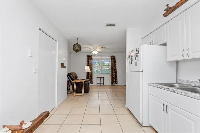 a white refrigerator freezer sitting inside of a kitchen
