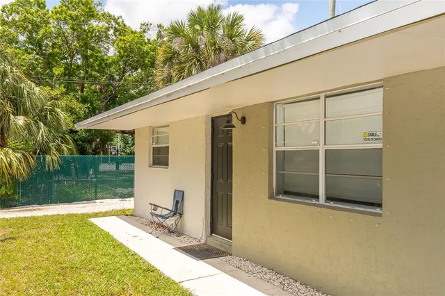 a front view of house with yard and trees around