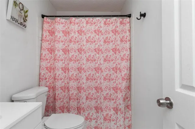 a kitchen with stainless steel appliances a white table a stove a microwave and a refrigerator