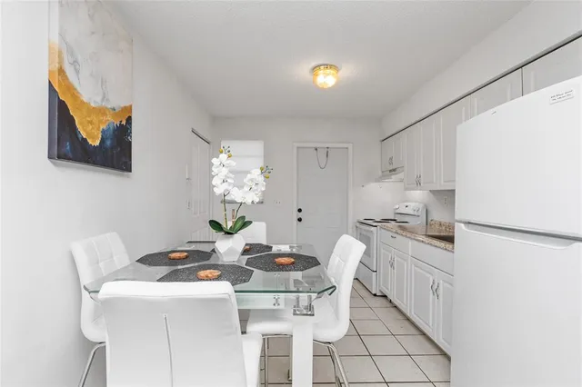 a view of a dining room that has a table and a chair in it