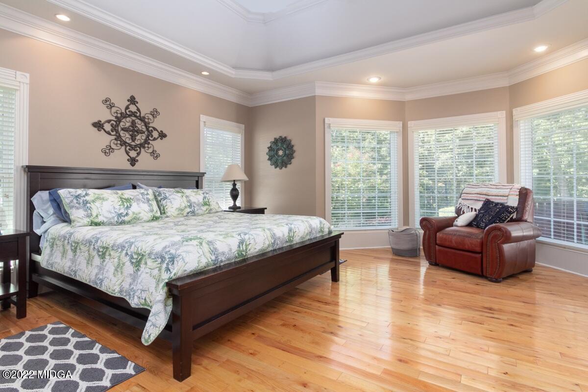 500 River Walk Forsyth, GA 31029 - Photo 13 of 31 a bedroom with a large bed and a couch