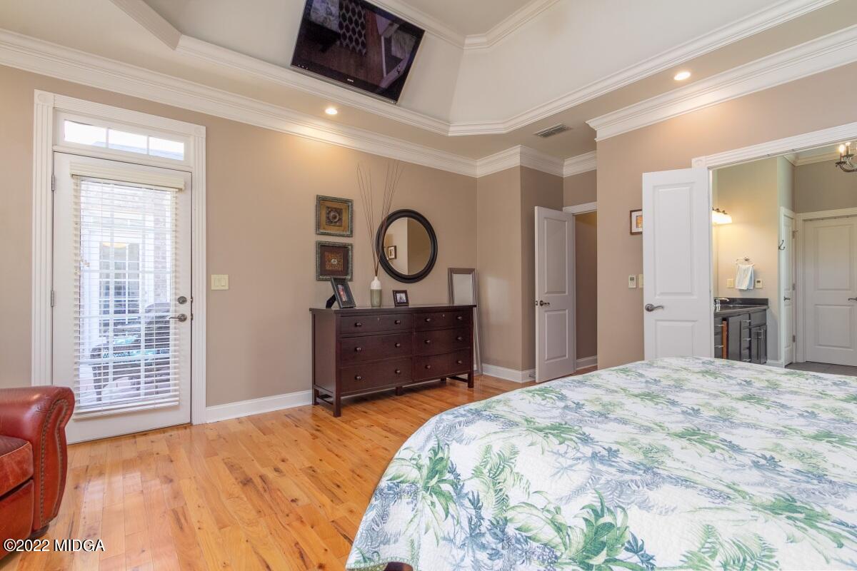 500 River Walk Forsyth, GA 31029 - Photo 14 of 31 a bedroom with a bed and a large mirror on the dresser
