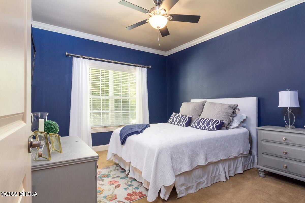 500 River Walk Forsyth, GA 31029 - Photo 17 of 31 a bedroom with a bed and a chandelier