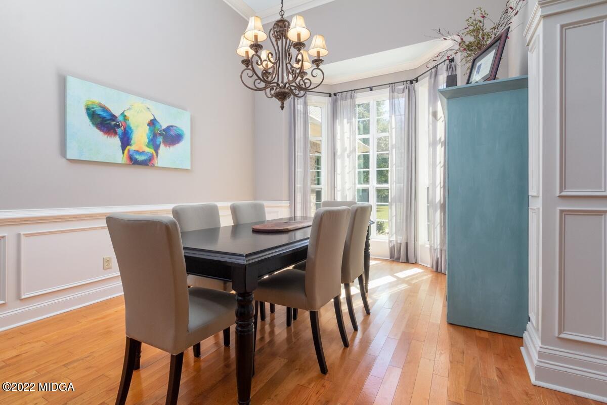 500 River Walk Forsyth, GA 31029 - Photo 5 of 31 a view of a dining room with furniture wooden floor and a chandelier