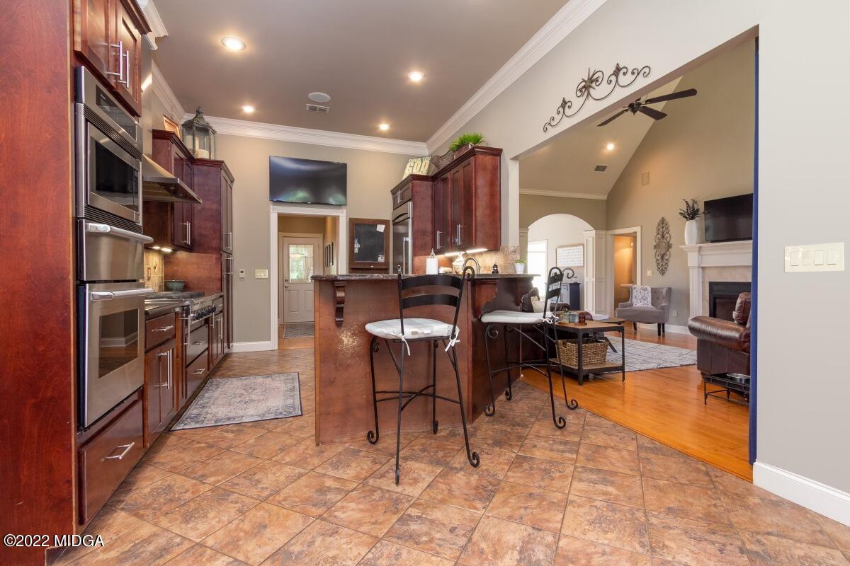 500 River Walk Forsyth, GA 31029 - Photo 8 of 31 a living room with lots of furniture and a book shelf