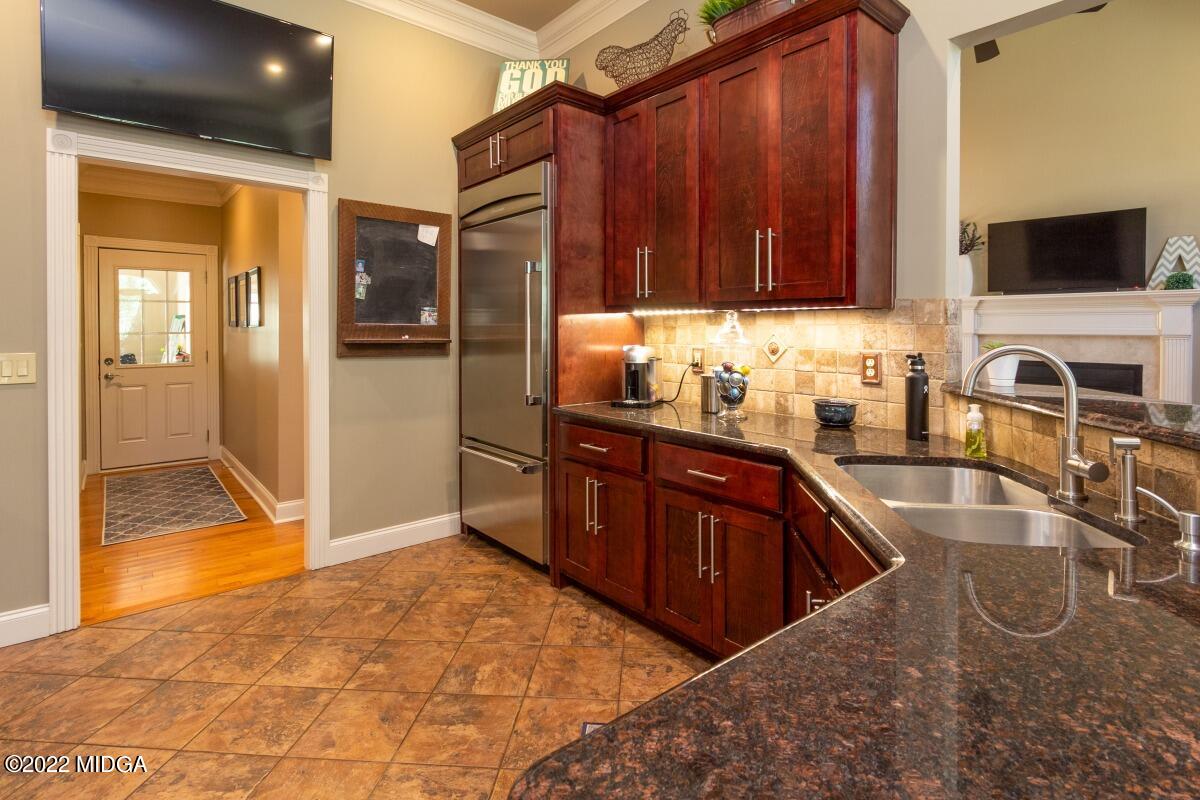 500 River Walk Forsyth, GA 31029 - Photo 9 of 31 a kitchen with granite countertop a sink and a stove top oven