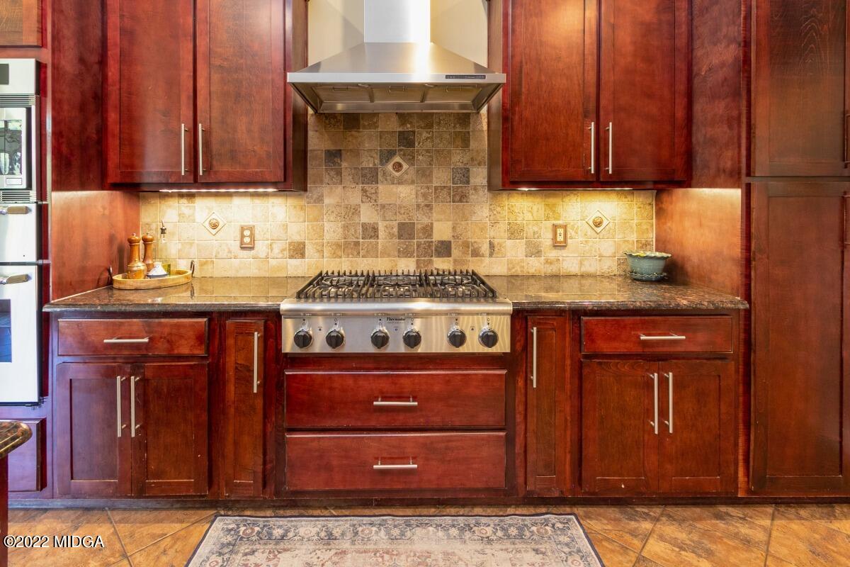 500 River Walk Forsyth, GA 31029 - Photo 10 of 31 a kitchen with stainless steel appliances granite countertop wooden cabinets and a stove top oven
