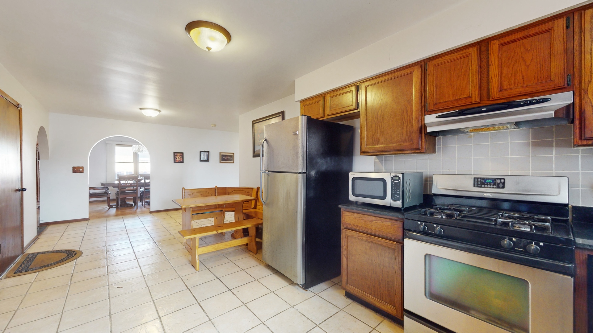 2105 16th Avenue Broadview, IL 60155 - Photo 8 of 26 a kitchen with stainless steel appliances granite countertop a stove a refrigerator and a sink